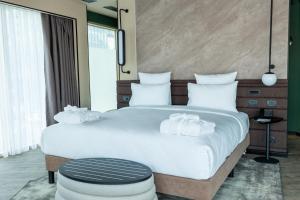 a bedroom with a large bed with white pillows at Novotel Istanbul Bomonti in Istanbul