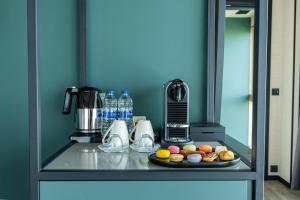a counter with a plate of food and a coffee maker at Novotel Istanbul Bomonti in Istanbul