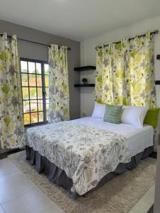 a bedroom with a bed with yellow and white curtains at Villa Nola in Port-of-Spain +26 photos
