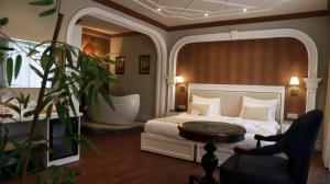 a bedroom with a bed and a table and a chair at DBD Hotel Bayraklı in Bayrakli