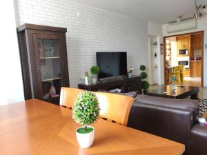 a living room with a table and a couch at ספרינג in Qiryat Shemona