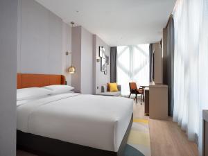 Voodi või voodid majutusasutuse Home2 Suite by Hilton Chongqing Wanzhou toas