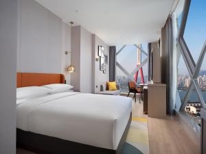 Voodi või voodid majutusasutuse Home2 Suite by Hilton Chongqing Wanzhou toas