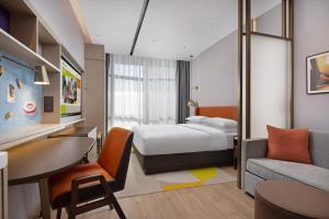 Voodi või voodid majutusasutuse Home2 Suite by Hilton Chongqing Wanzhou toas