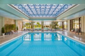 a large swimming pool with a glass ceiling at Sheraton Rhodes Resort in Ixia