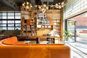 a room with an orange couch and a table at Okupa in Athens