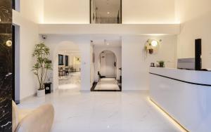 a living room with white floors and a lobby at The Royal Sky - Phu My Hung in Ho Chi Minh City