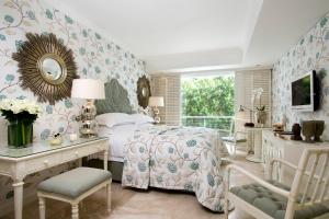 a bedroom with a bed and a desk and a mirror at Twelve Apostles Hotel & Spa in Cape Town +123 photos