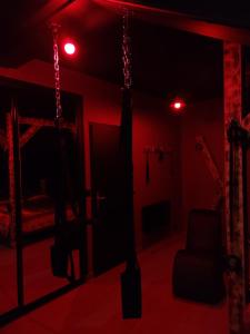 a red room with a bed and a chair at La Love room in Arbois