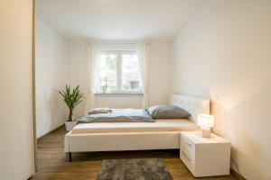 a small bedroom with a bed and a window at Möblierte Penthaus Wohnung in Baden-Baden +15 photos