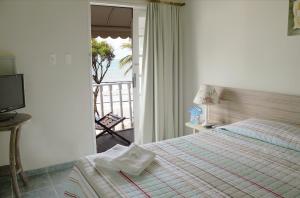 En eller flere senger på et rom på Sol Nascente Hotel Pousada Beira Mar