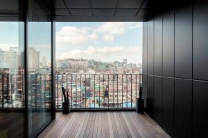 a room with a view of a city from a building at Handpicked Hotel & Collections in Seoul