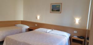 Postel nebo postele na pokoji v ubytování Hotel Tre Re