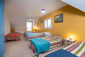 a room with four beds in a room at Villa - Piscine chauffée, jacuzzi in Plouharnel +24 photos