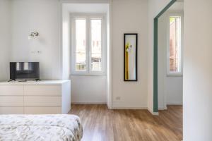 A bed or beds in a room at VATICAN COZY APARTMENT - GIULIANA