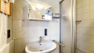 a small bathroom with a sink and a shower at Smart Resorts B&B 3 BB 1004 in Winterberg +11 photos