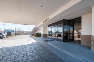 a building with glass doors on a street at Quality Inn in Baltimore