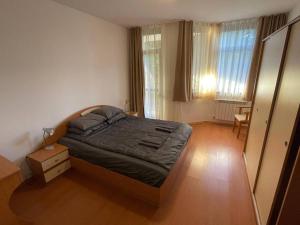 a bedroom with a bed and a dresser in it at FLORA Apartment Hotel 412 in Borovets +20 photos