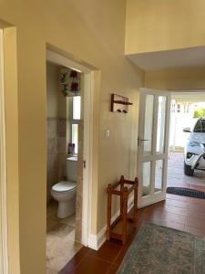 a bathroom with a toilet and a door to a driveway at Precious, Peaceful 3bedroom, 6 sleeper family home! in Balfour +35 photos