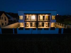 a house at night with its lights on at KOA - Nest in Braşov