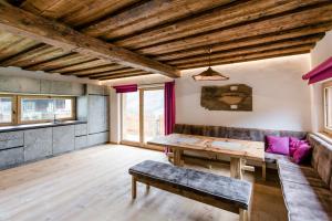 a dining room with a wooden table and a bench at Chalet Wildberg in Grossarl