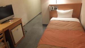 Tempat tidur dalam kamar di Hotel Folkloro Ominato