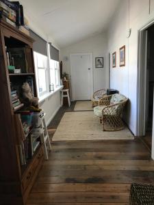 a living room with a couch and a chair at Swanpool - Serendipity House in Swanpool