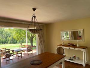 a dining room with a table and a view of a yard at Precious, Peaceful 3bedroom, 6 sleeper family home! in Balfour