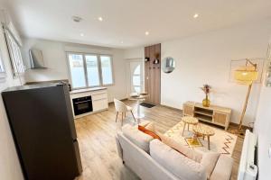 a living room with a couch and a table at Lovely ! T2 neuf archi cosy 1 in Quimperlé