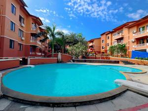 a large swimming pool in a courtyard with buildings at Jack & Rose Stays in Orlim