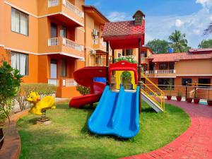 a playground with a slide in front of a building at Jack & Rose Stays in Orlim
