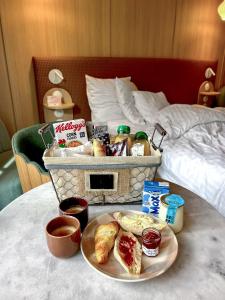 a breakfast tray with bread and pastries on a bed at Aparthotel AMMI Nice Lafayette in Nice +37 photos