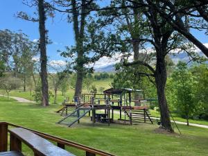 a park with benches and a playground in the grass at Precious, Peaceful 3bedroom, 6 sleeper family home! in Balfour