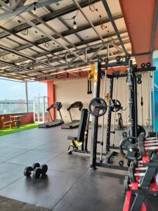 a gym with several treadmills and weights on the floor at G.C ROYAL HOTEL in Accra