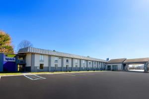 an empty parking lot in front of a building at Spark by Hilton Daleville Roanoke North in Daleville