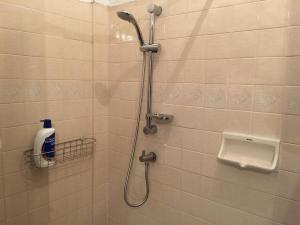 a bathroom with a shower with a toilet and a sink at 42 Guest House in Bangkok +16 photos