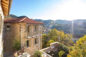 a stone house with a balcony on a hill at Miglari in Stemnitsa