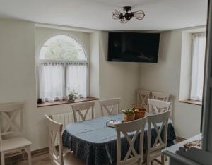 a dining room with a table and chairs and a window at Casa Rural La Medica in Sargentes de la Lora