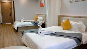 a hotel room with two beds with towels on them at G.C ROYAL HOTEL in Accra