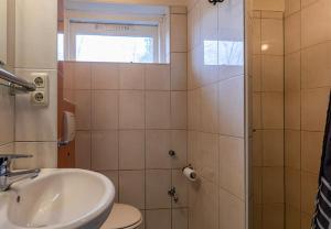 ein Badezimmer mit Waschbecken, Toilette und Dusche in der Unterkunft Bungalowpark Simpelveld - Alpha 105 in Simpelveld