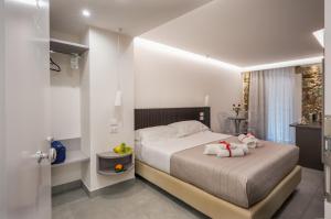 a bedroom with a bed with two stuffed animals on it at Taormina charming rooms in Taormina