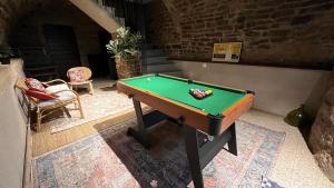 a pool table in the middle of a room at Maison Rosie in Voiteur