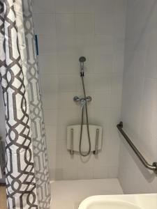 a bathroom with a shower curtain and a toilet at Albergue El Muro in Monforte de Moyuela +45 photos