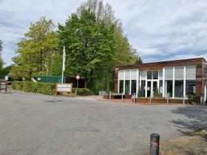 a building with a sign in front of it at Bungalowpark Simpelveld - Delta 130 in Simpelveld