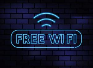 a neon sign with a free wifi sign on a brick wall at Bromsgrove Hotel in Bromsgrove