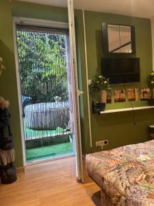 a bedroom with a sliding glass door with a fence at Tropical Room in Brussels