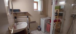 a small bathroom with a sink and a shower at Gîtes à 30 min de la Pointe du Raz in Mahalon +22 photos
