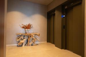 a room with a table with a vase on it at Templo Hotel & SPA in Braga +66 photos