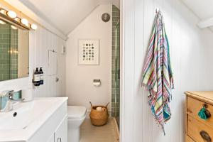 a bathroom with a sink and a toilet at Waterside cottage - log burner - 10 mins to Falmouth in Flushing +31 photos