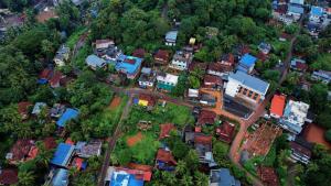 an overhead view of a city with houses and trees at Hotel Diamond Castle in Manjeri
